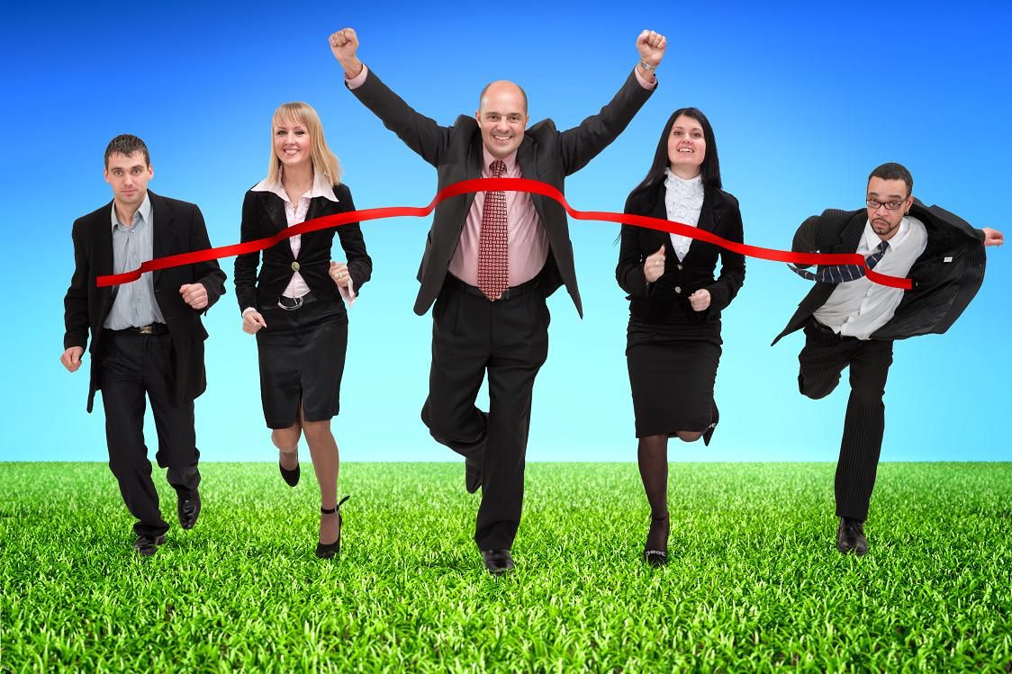Business people crossing finish line