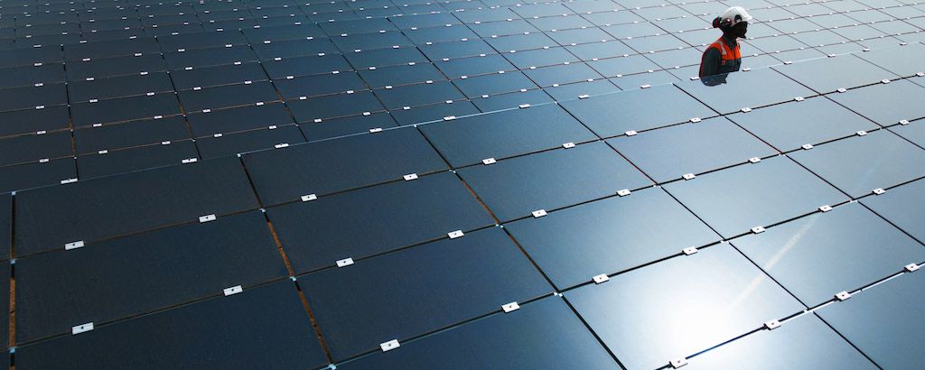 O&M Engineer walking between solar panels